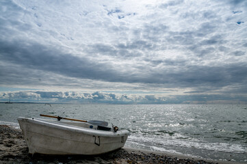 Boat on the sea beach at twilight on a summer day