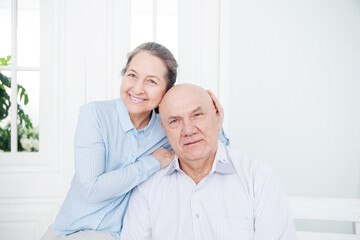 Elderly woman embracing mature man.