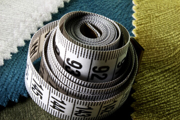 measuring tape on a fabric background