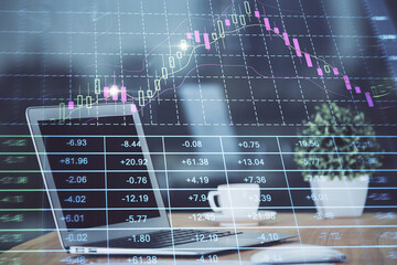 Stock market graph on background with desk and personal computer. Multi exposure. Concept of...