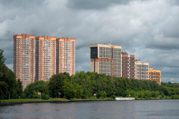 Fototapeta na wymiar High-rise new buildings on a green hill. Khimki District, Moscow