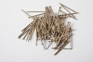 Heap of Metal gold color Nails on white background