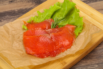 Sliced salmon fillet served rosemary