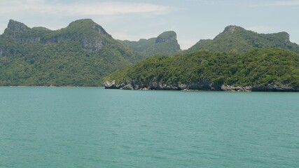 Obraz premium Group of Islands in ocean at Ang Thong National Marine Park near touristic Samui paradise tropical resort. Archipelago in the Gulf of Thailand. Idyllic turquoise sea natural background with copy space