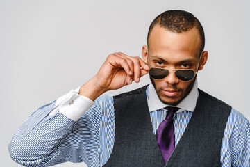 African-American businessmanman wearing glasses portrait over grey background