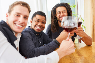Group of men drinking wine together at home