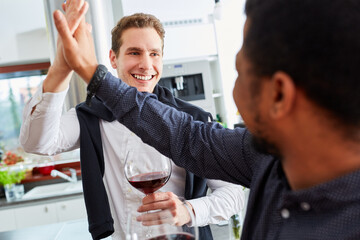 Men as friends give each other high five by hand at home