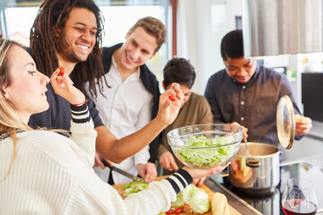 Students prepare salad together in shared kitchen