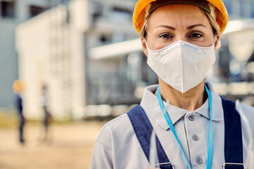 Fototapeta na wymiar Female building contractor wearing protective face mask at construction site.
