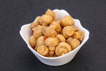 Pickled champignons in the bowl