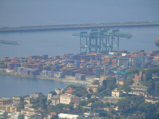Genova, Italy – 07/30/2020: Beautiful scenic aerial view of the city, port, dam, sea, Cristoforo Colombo airport runway, containers shipping terminal, Pra, Voltri, and Sestri promontory from Monte Gaz