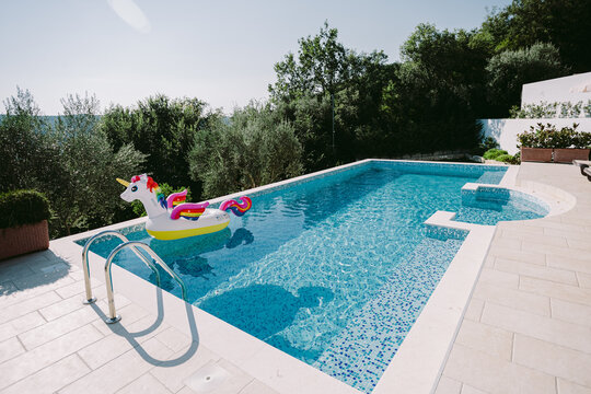 Inflatable Toy Pool Floating Unicorn. Summer Vacation Time With Fun Beach Floaties In Swimming Pool. No People.