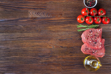Raw steak with spices and ingredients for cooking. Flat lay. Top view.