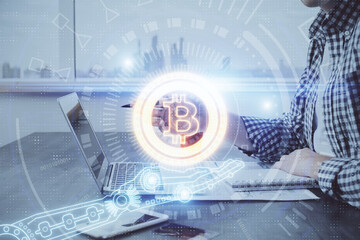 Blockchain theme hud with man working on computer on background. Concept of crypto chain. Double exposure.