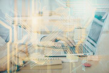 Multi exposure of world map hologram with man working on computer on background. Concept of worldwideweb.