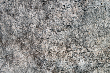 Close up view onto rough texture of granite's surface & its grained structure