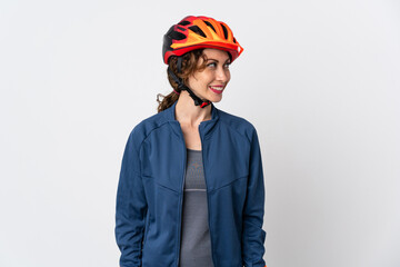 Young cyclist woman isolated on white background looking side