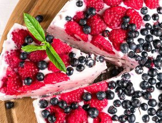 Raspberry Cheesecake Close Up With A White Wood Background