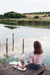 girl enjoying picnic on a wooden pie