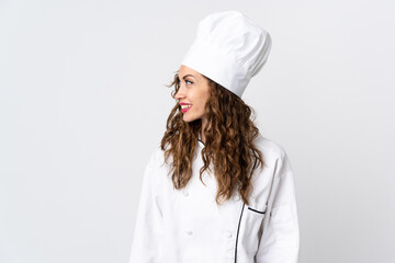 Young chef woman isolated on white background looking side