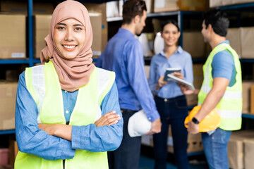 Islam Muslim female warehouse worker portrait with her team - Powered by Adobe