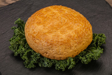 Smoked Georgian suluguni cheese piece