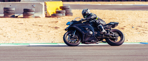 motorcycle racer rides on a sports track