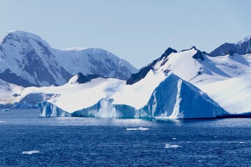 Beautiful antarctic landscape, blue iceberg, glacier, sun, blue sky, Antarctica