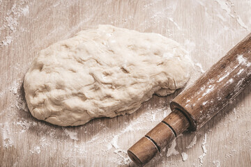 dough and wooden rolling pin close-up