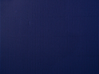 Empty dark blue colored corrugated background texture. The concept for image, text, design..