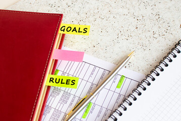 A business diary with colored tabs with inscriptions lies on financial charts on the office desk.