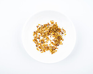 Osmanthus tea in a saucer on white background