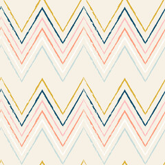 Ikat vector seamless pattern. Chevrons in pastel colors on light background. Modern geometric background in retro style.