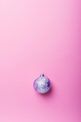Christmas violet ball on the pink background