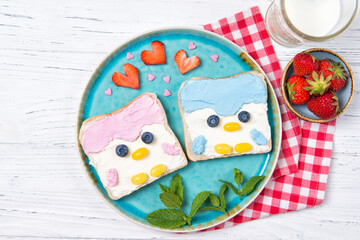 Penguin toasts with colored spread on a plate, food for kids idea