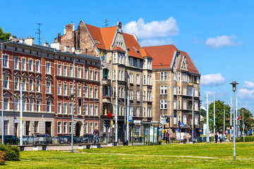 Solidarnosci square and surrounding tenement houses in old Gdansk Shipyard quarter in front of European Solidarity Centre in Gdansk, Poland - obrazy, fototapety, plakaty