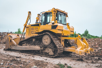 industrial machines clean the landfill and produce fine waste