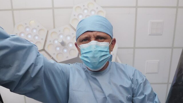 The pathologist opens a plastic bag with a dead body inside the hospital morgue. A corpse in a black plastic bag. First-person view, conceptual footage