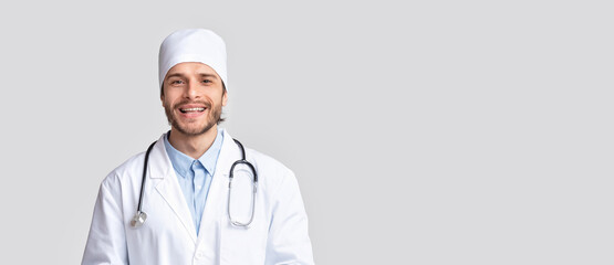 Professional medical doctor in uniform smiling at camera