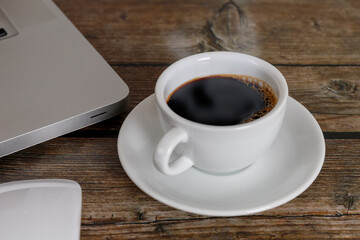 Close up laptop, mouse coffee on wood table. Laptop, mouse, black coffee on wood background coffee concept.