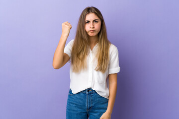 Fototapeta na wymiar Young woman over isolated purple background with unhappy expression