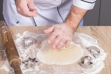 male cook preparing Christmas cookies