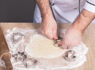 male cook preparing Christmas cookies