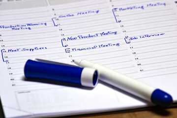 scheduling meeting time on a notepad to fix a business meeting
