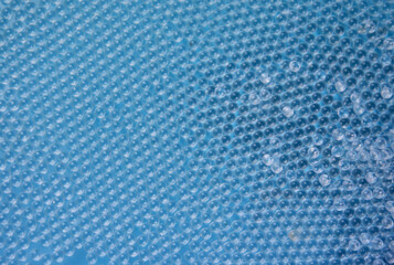 Small glass solid balls blue background stock images. Pile of crystal clear beads images. Shiny...