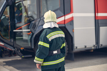 Back view of man at the fire station in outdoors