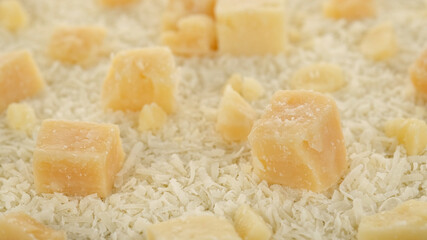 parmesan cheese grated and pieces close up