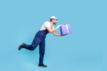 Express service. Side view, professional courier in overalls and protective gloves running to give...