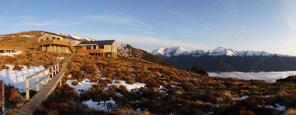 Wall mural sunrise with orange cloud cover seen from luxmore hut in the fiordland national park along the keple