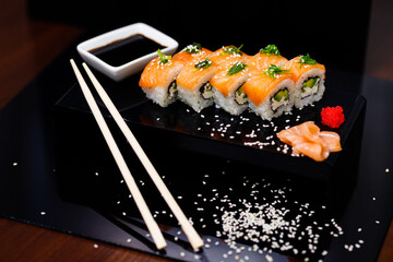 Sushi with salmon. Soy sauce, ginger, red caviar. Roles with red fish.